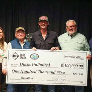 Picture of Riley Green presenting check at Duckman Jam